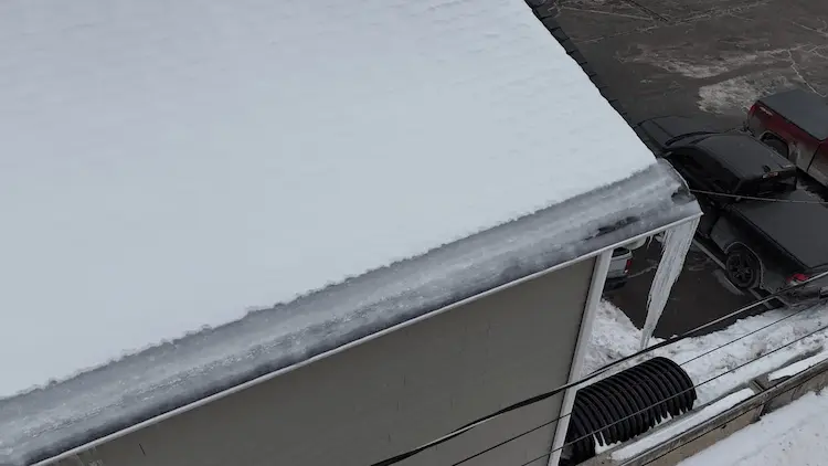 Winter asphalt shingle roof in Lackawanna County Pennsylvania with snow and cold weather conditions.