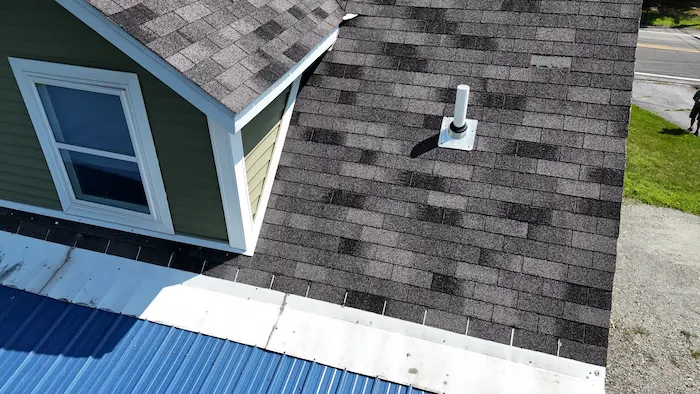 Metal roof and asphalt shingle roof meeting on a home in Lackawanna County Pennsylvania