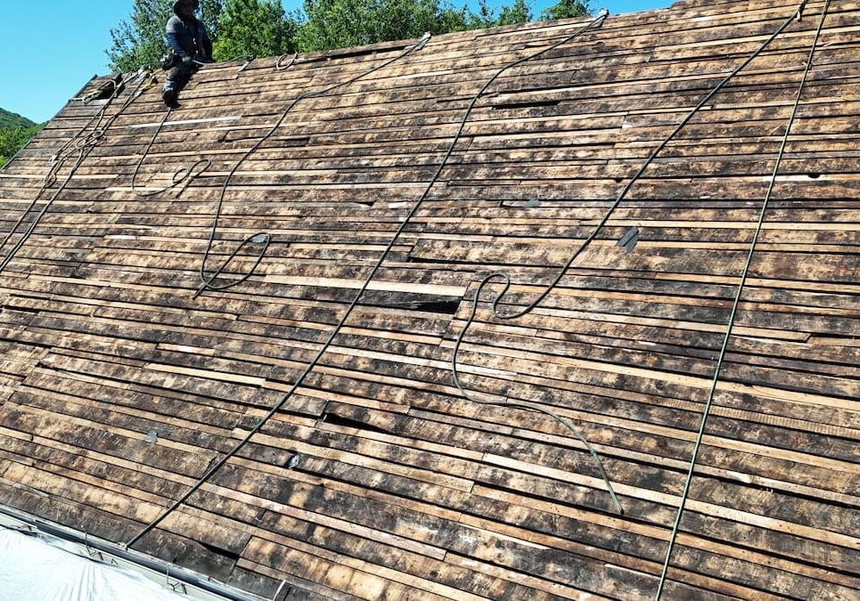 Damaged roof decking found after old shingles were removed during a full tear-off roof replacement.