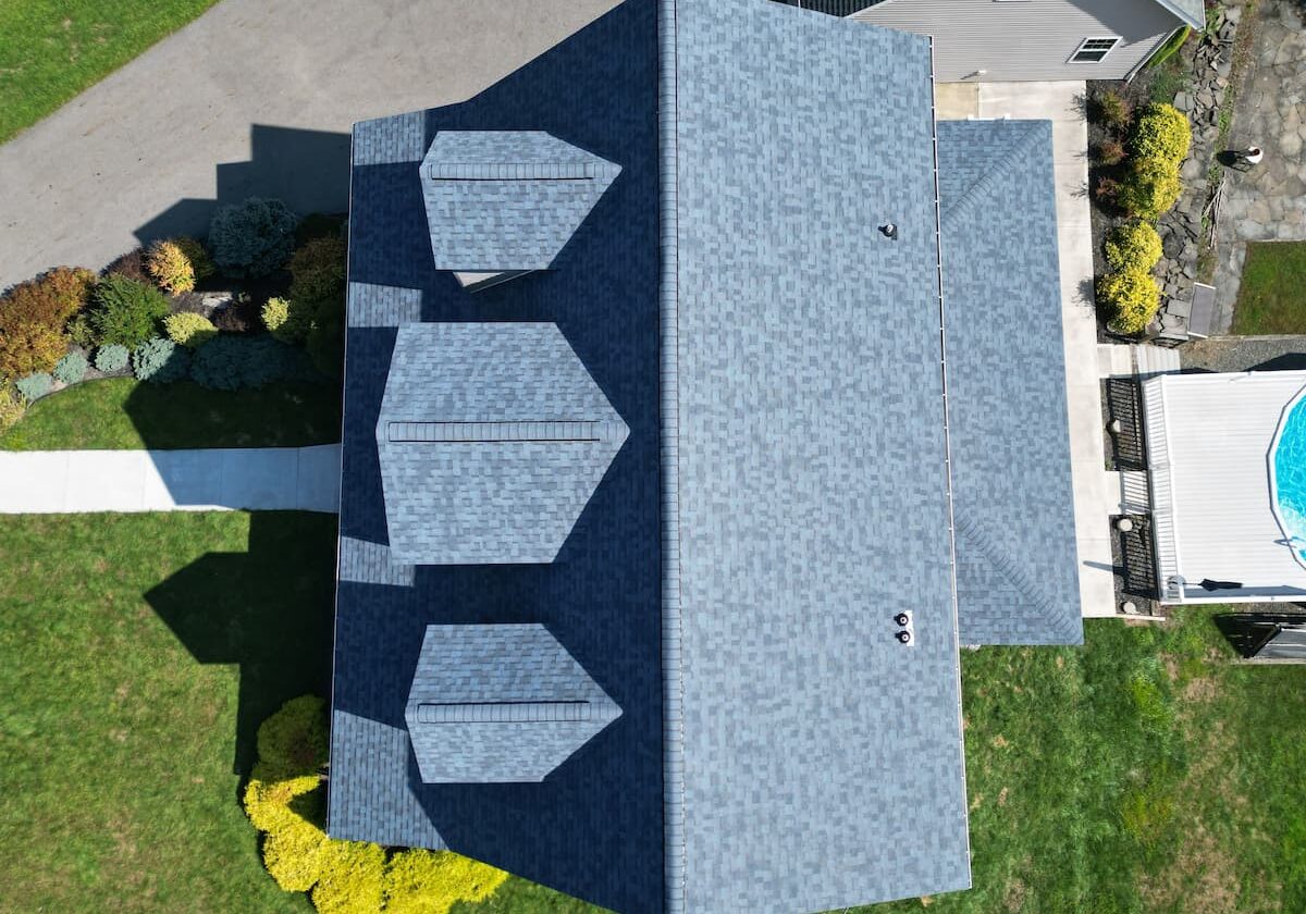 Aerial view of house with blue roof