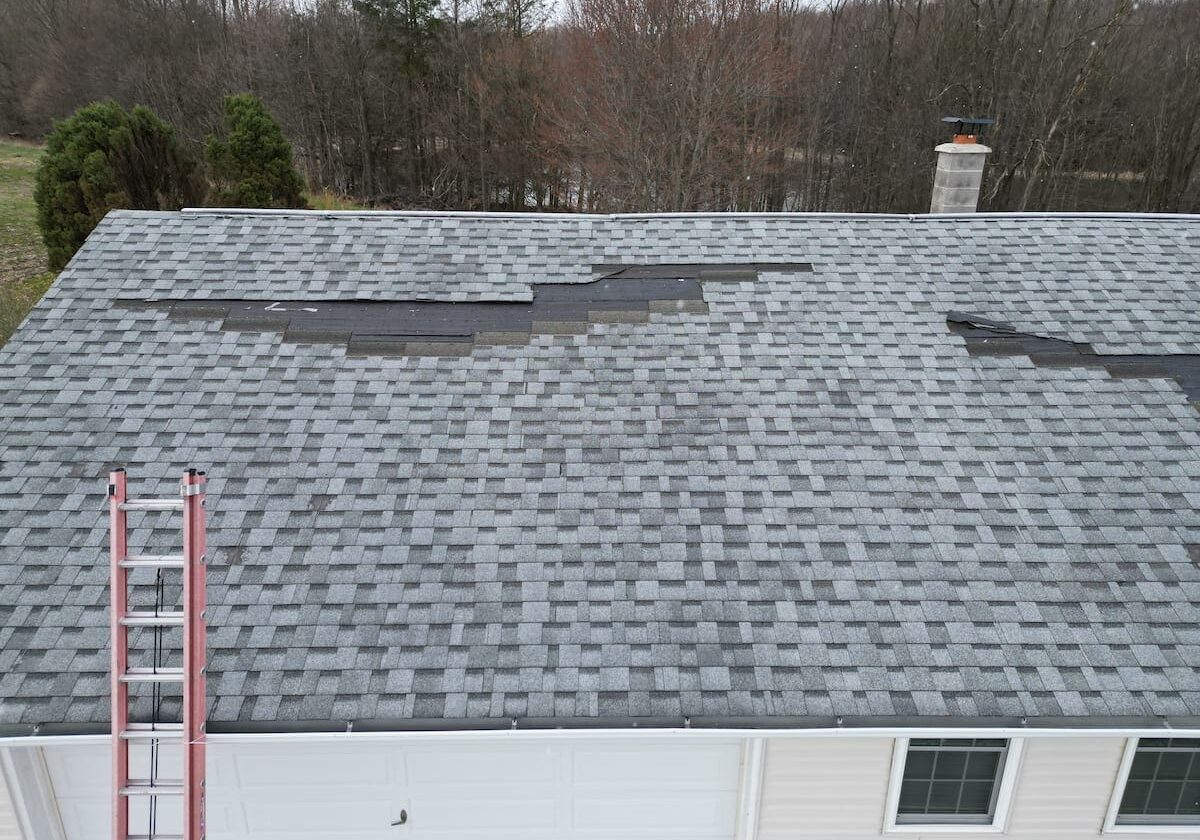 Roof repair project in Olyphant PA showing damaged shingles and repair work completed by Zenobi Roofing Inc