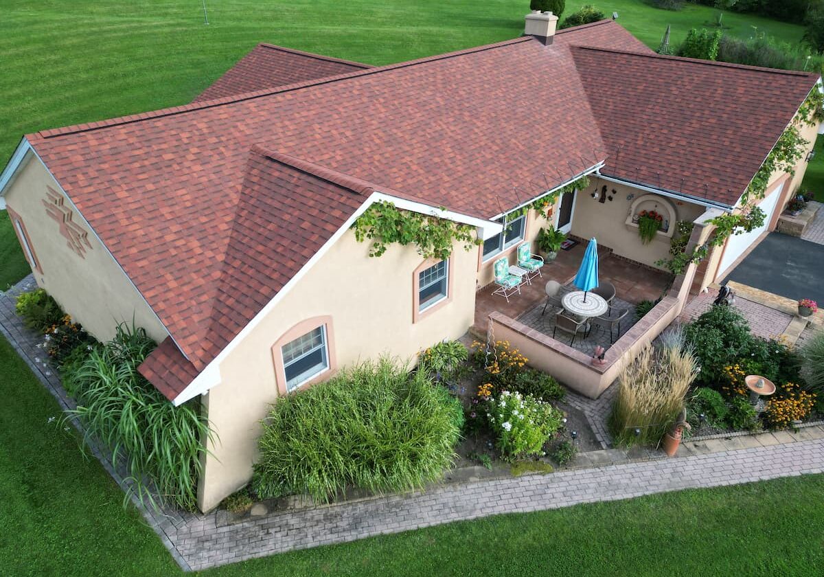 Aerial view of red-shingle roof and patio